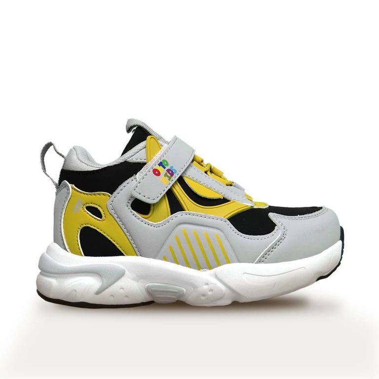 Childs sneaker with white, yellow, and black color blocking, featuring velcro straps and chunky white sole